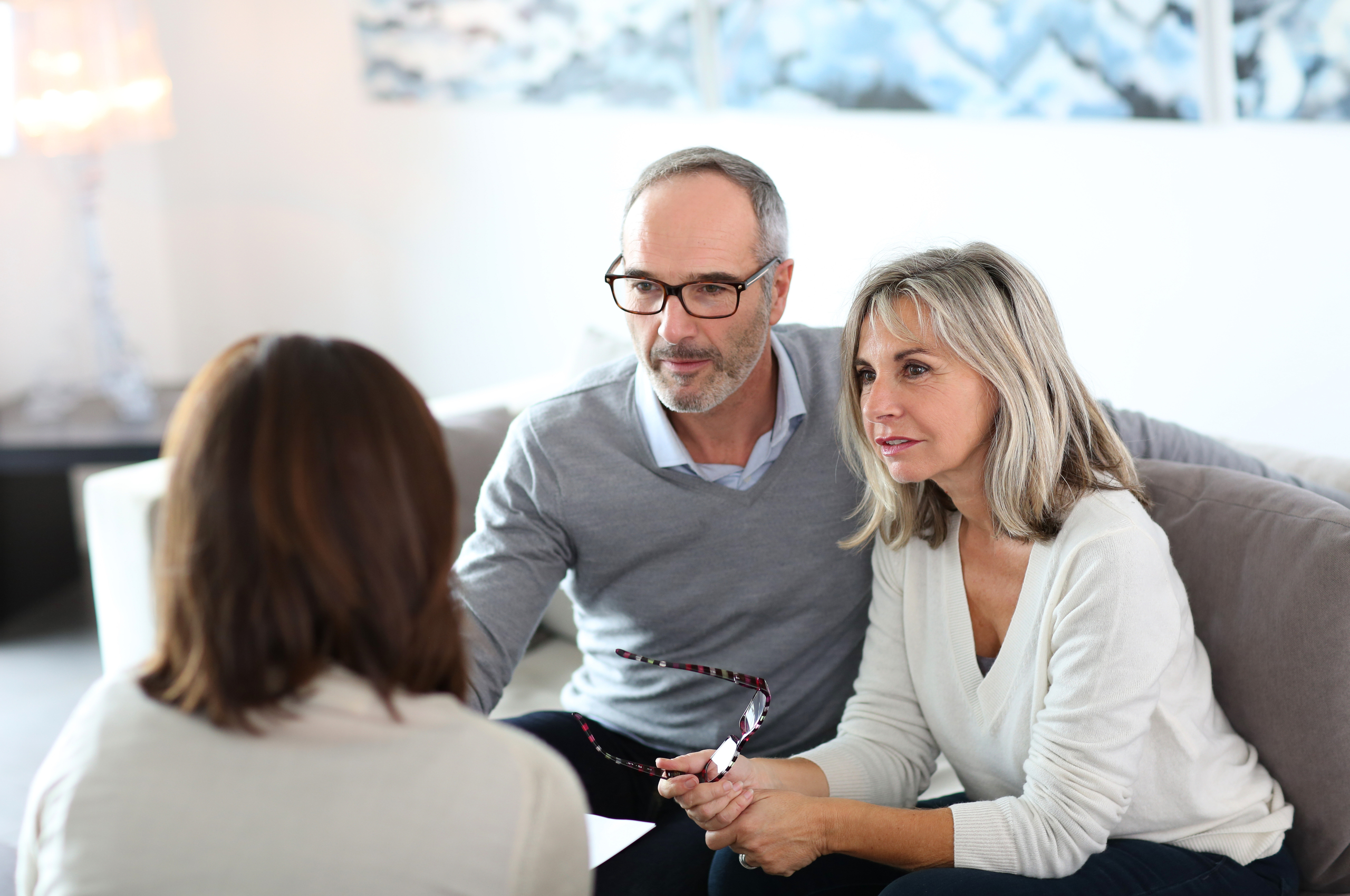 A couple consults with a financial adviser. 