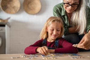 Woman and young girl assembling a puzzle