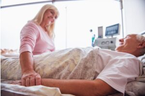 A woman visits her husband in hospital.