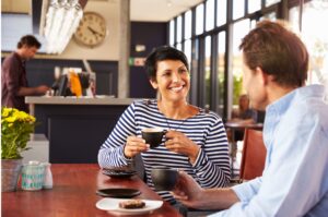 A couple enjoys a cup of coffee in a café.