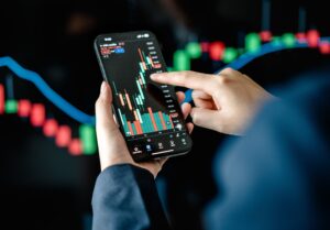 An investor checks a stock market graph on their phone.