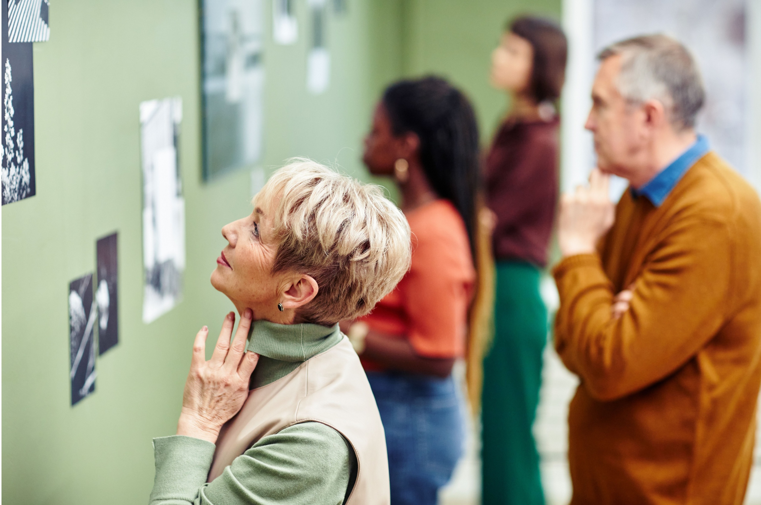 A woman looking at pictures in an art gallery