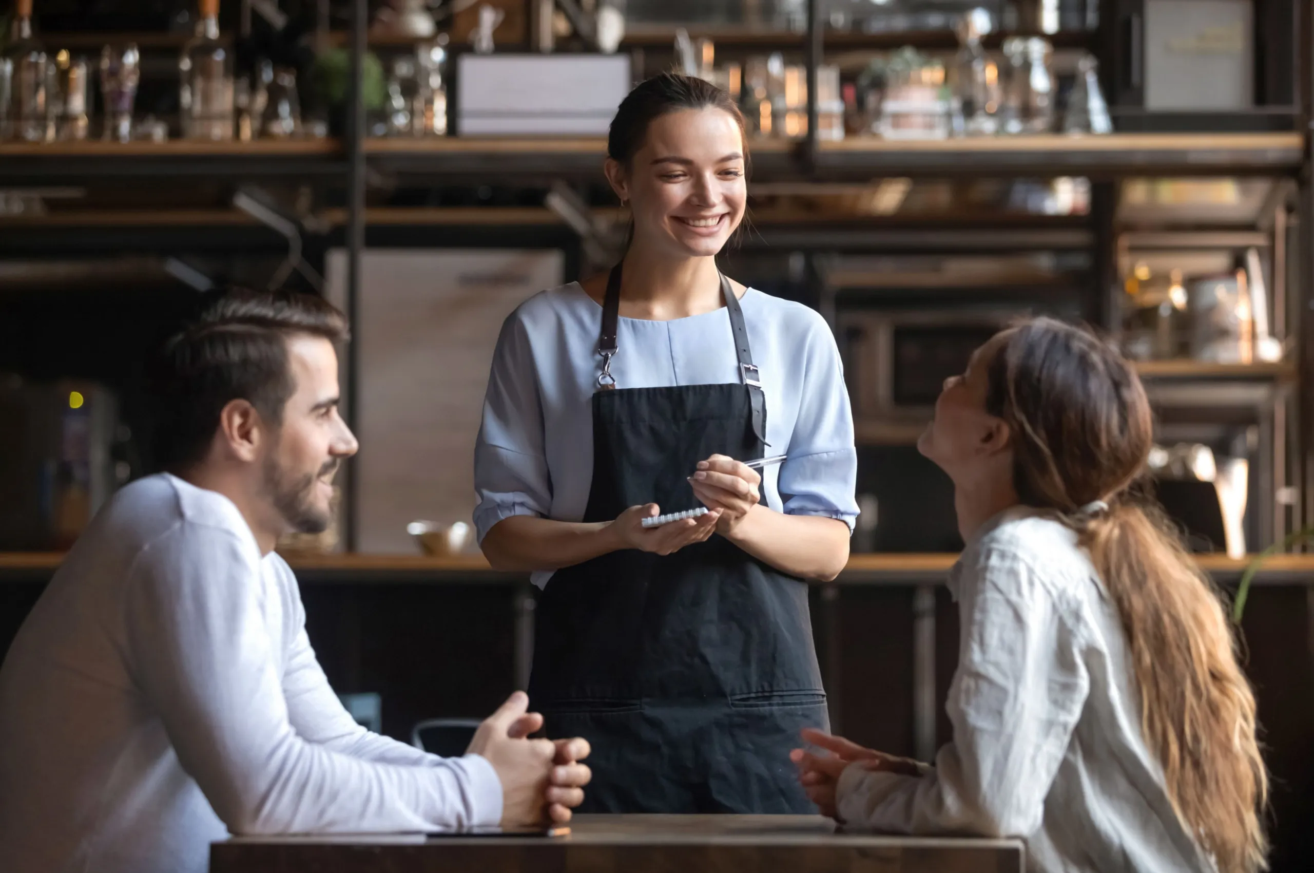 A couple ordering with a waitress.